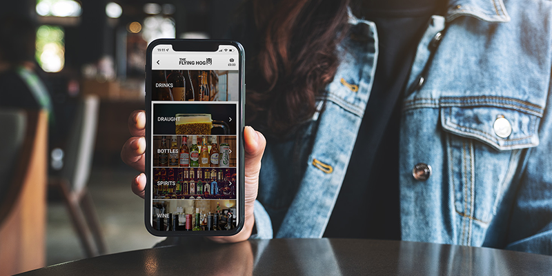 Woman holding phone to camera showing menu