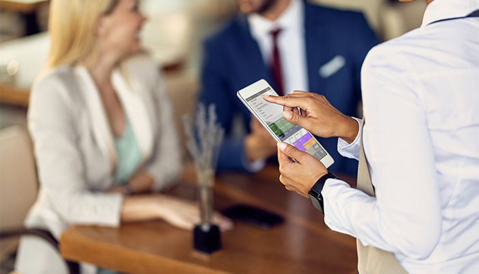 Waitress using PocketTouch ordering software by ICTouch at the table