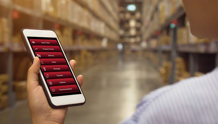 Person using phone to check stock in a warehouse