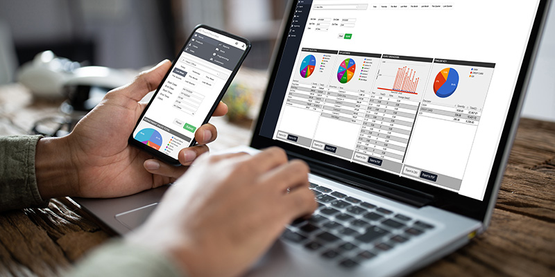 Laptop and phone displaying TouchOffice Web software by ICRTouch