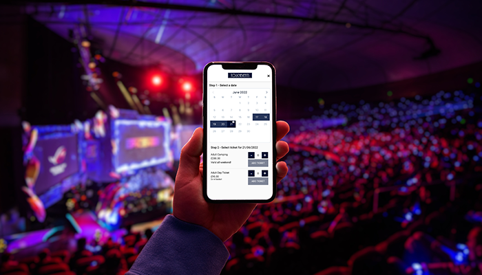 phone holding up in crowed displaying ticketing software